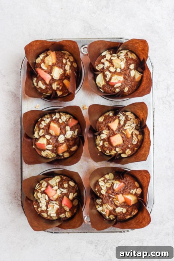 warm apple cinnamon muffins cooling on a wire rack