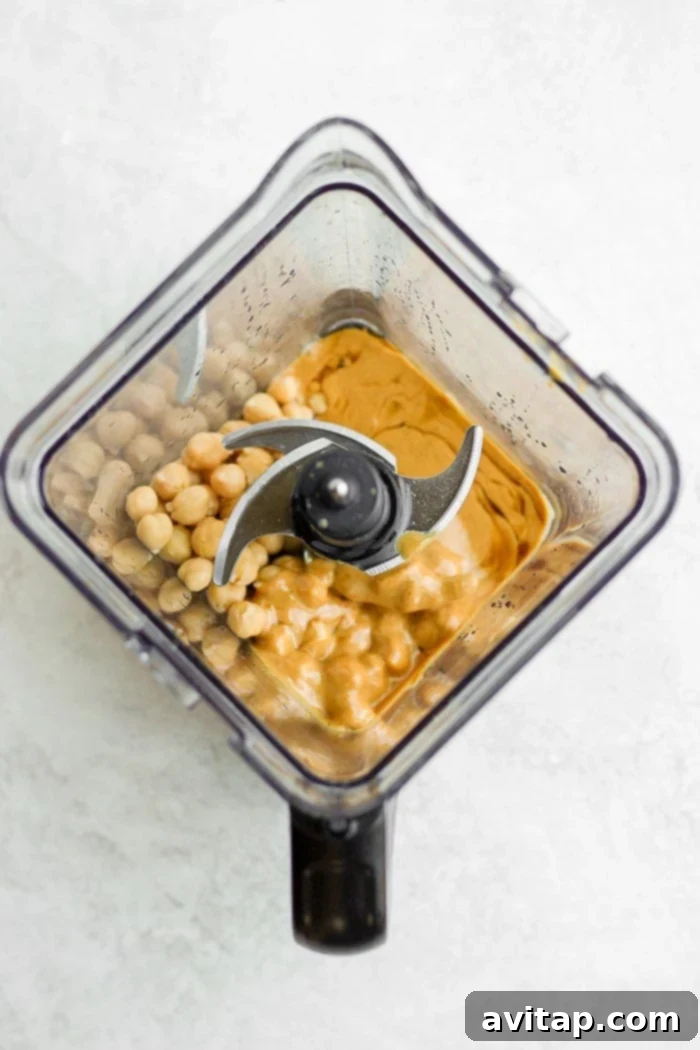 Close-up of ingredients in a high-speed blender for cake batter dip