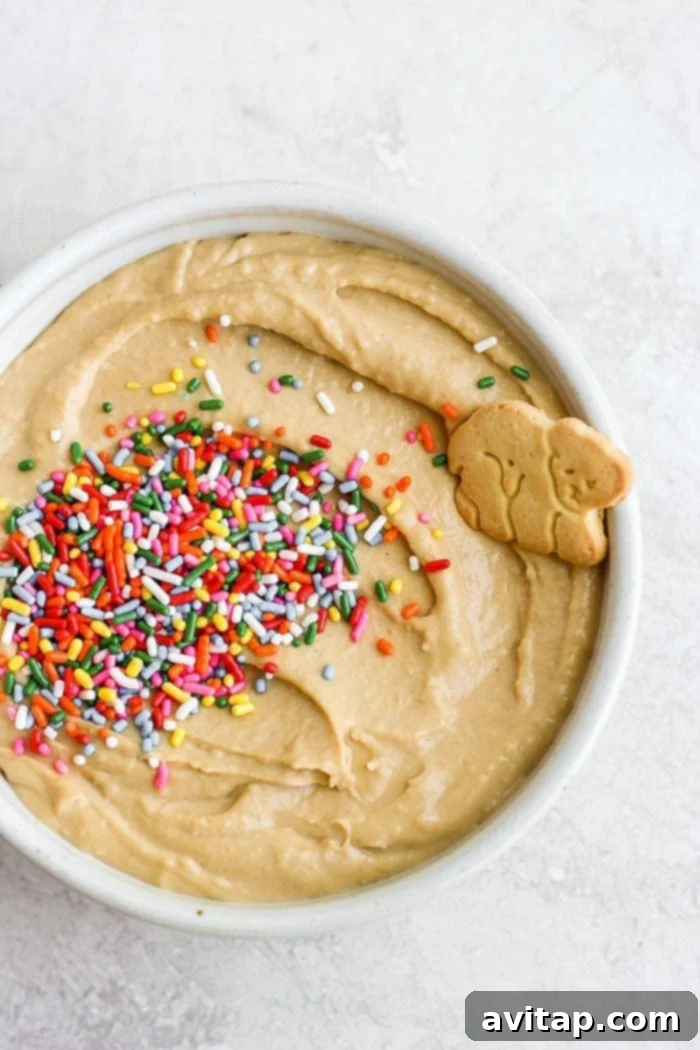 A bowl of vibrant funfetti cake batter dip ready for serving