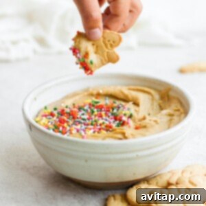 A bowl of peanut butter hummus topped with sprinkles.