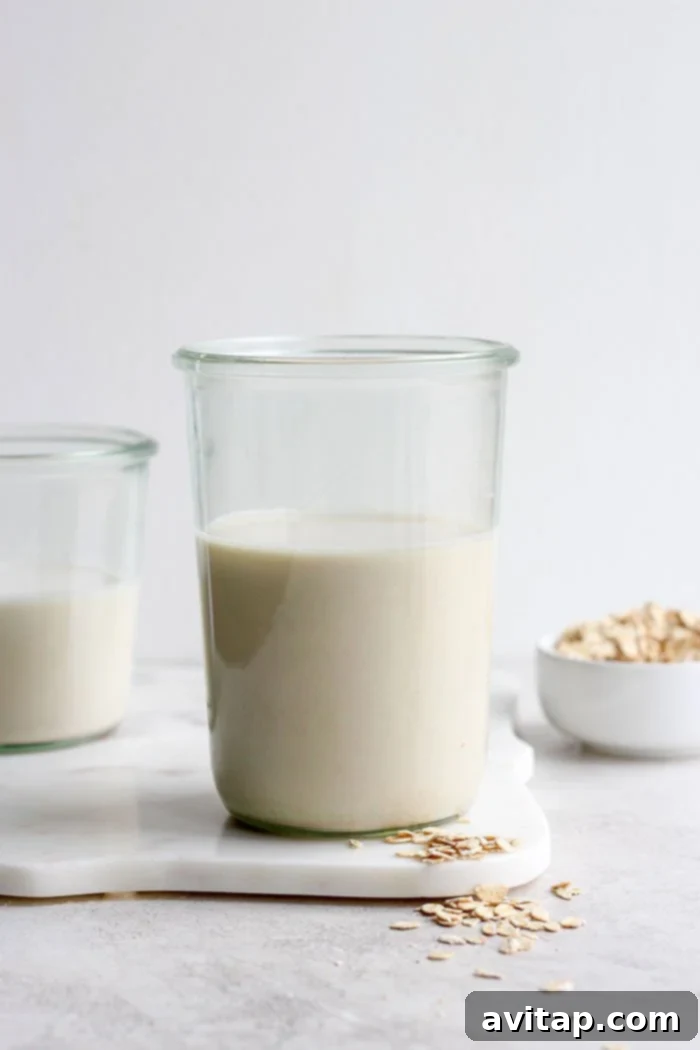 Freshly made oat milk in a glass on a table