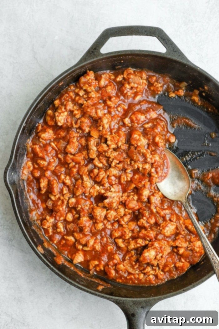 The perfectly savory and sweet Healthy Sloppy Joe Recipe is here! Made with ground chicken and a flavorful sauce packed with clean ingredients, these Sloppy Joes will not disappoint! Healthy sloppy joes in a skillet, ready to be served