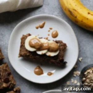 Wholesome Banana Oatmeal Bars 2 A plate with healthy banana oatmeal bars, fresh bananas, and peanut butter, highlighting the main ingredients and a serving suggestion.