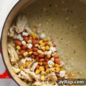 Zesty Chicken and White Bean Chili 5 All ingredients for white chicken chili mixed together in a pot, simmering to perfection.