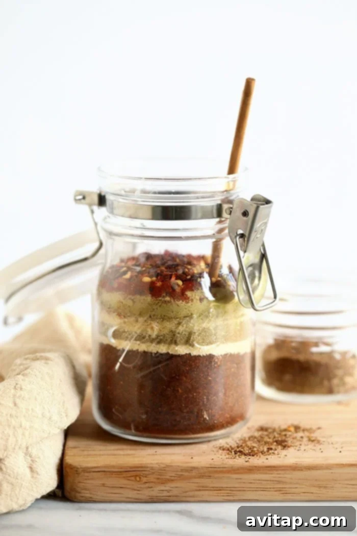 Simple and delicious homemade taco seasoning blend in a jar, perfect for any kitchen. Homemade taco seasoning stored in a clear glass jar, ready for use, against a rustic backdrop.