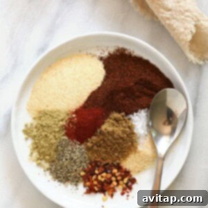 All the taco seasoning ingredients measured out and placed together on a small plate, ready to be mixed.