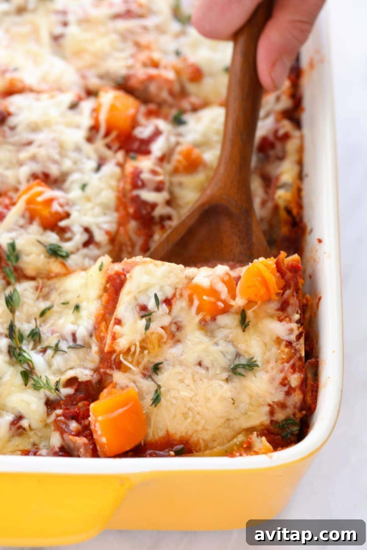 A spatula scooping out a perfect piece of butternut squash lasagna, showcasing its beautiful layers.