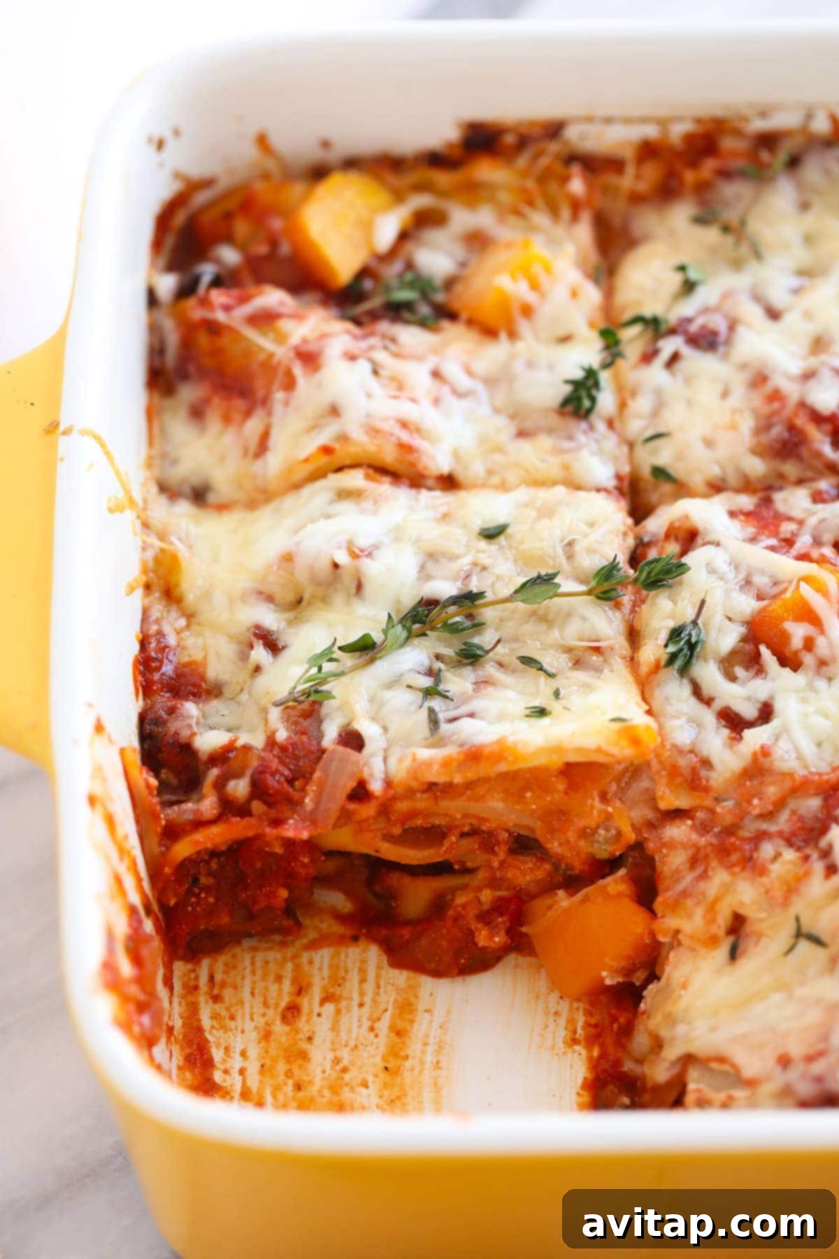 A close-up view of the perfectly formed layers in a healthy butternut squash lasagna slice.
