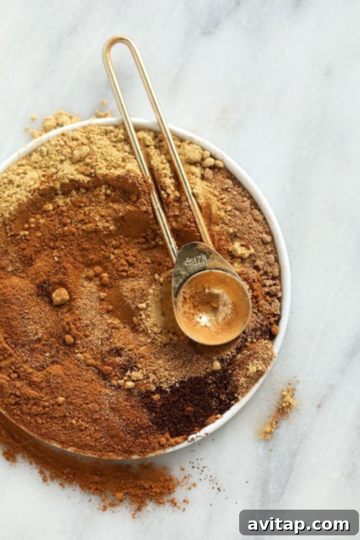 An array of individual pumpkin pie spices artfully arranged on a plate, highlighting their distinct colors and textures.