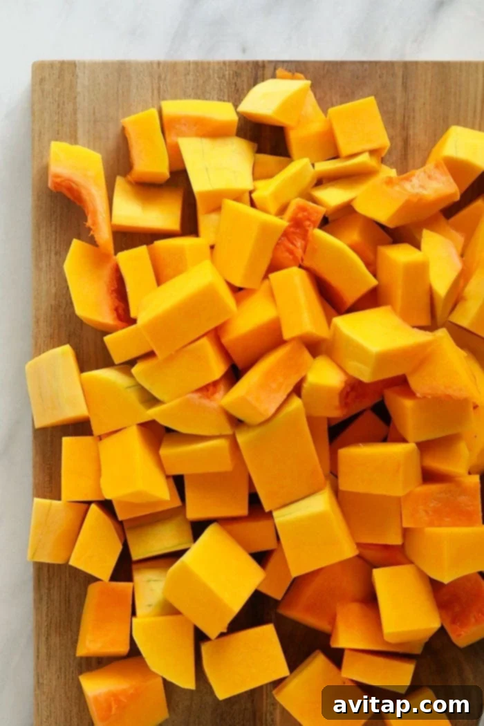 Instant Pot Butternut Squash Recipe 4 Neatly cubed butternut squash pieces on a cutting board, ready for cooking.
