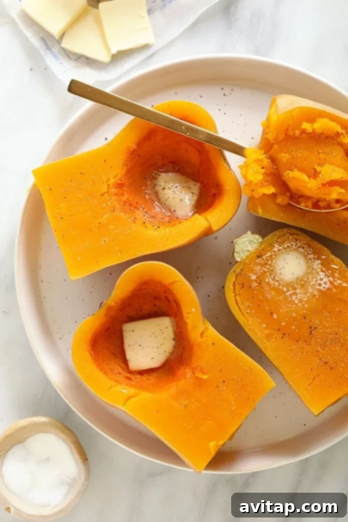 Instant Pot Butternut Squash Recipe 7 A bowl of cooked butternut squash, lightly seasoned with a pat of butter melting on top.