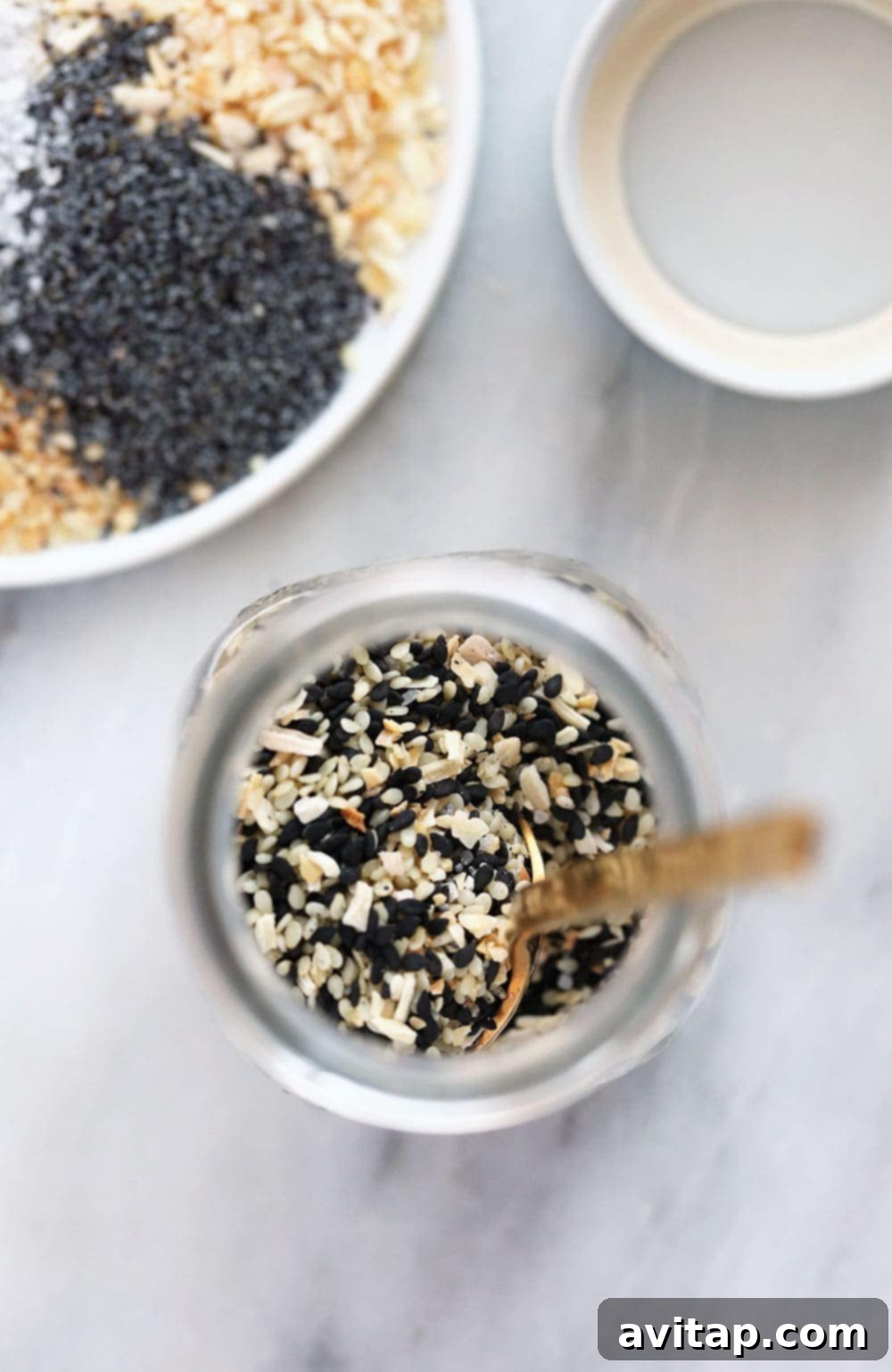 Homemade Everything Bagel Seasoning stored in a clear glass jar