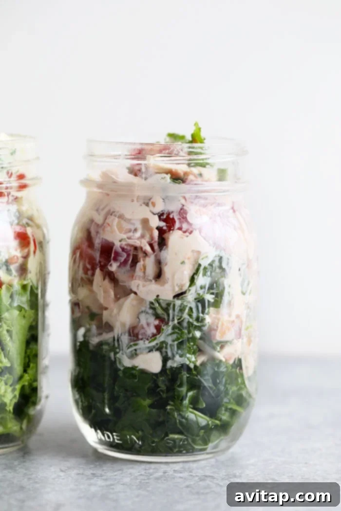 Delicious BLT Chicken Salad: A healthy and flavorful lunch solution perfect for meal prep. Healthy BLT chicken salad beautifully presented in a mason jar, showcasing layers of fresh ingredients.