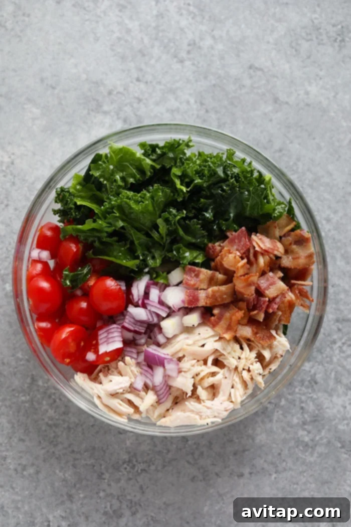 Fresh and Wholesome: The vibrant ingredients that make up our delicious BLT Chicken Salad. All the fresh ingredients for a healthy BLT chicken salad, neatly arranged in a bowl before mixing.