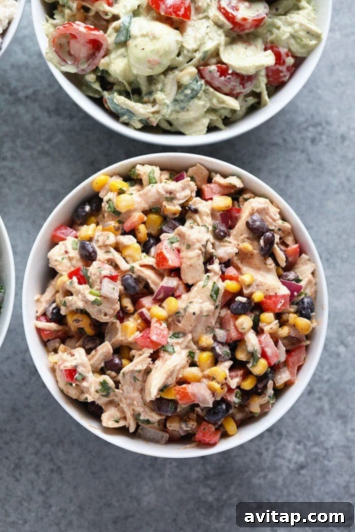 A vibrant bowl of Southwest Chicken Salad, showcasing shredded chicken, colorful vegetables, and creamy dressing.