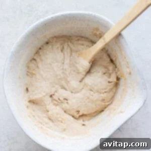 Fluffy pancake batter in a bowl, showing its thick and airy consistency.