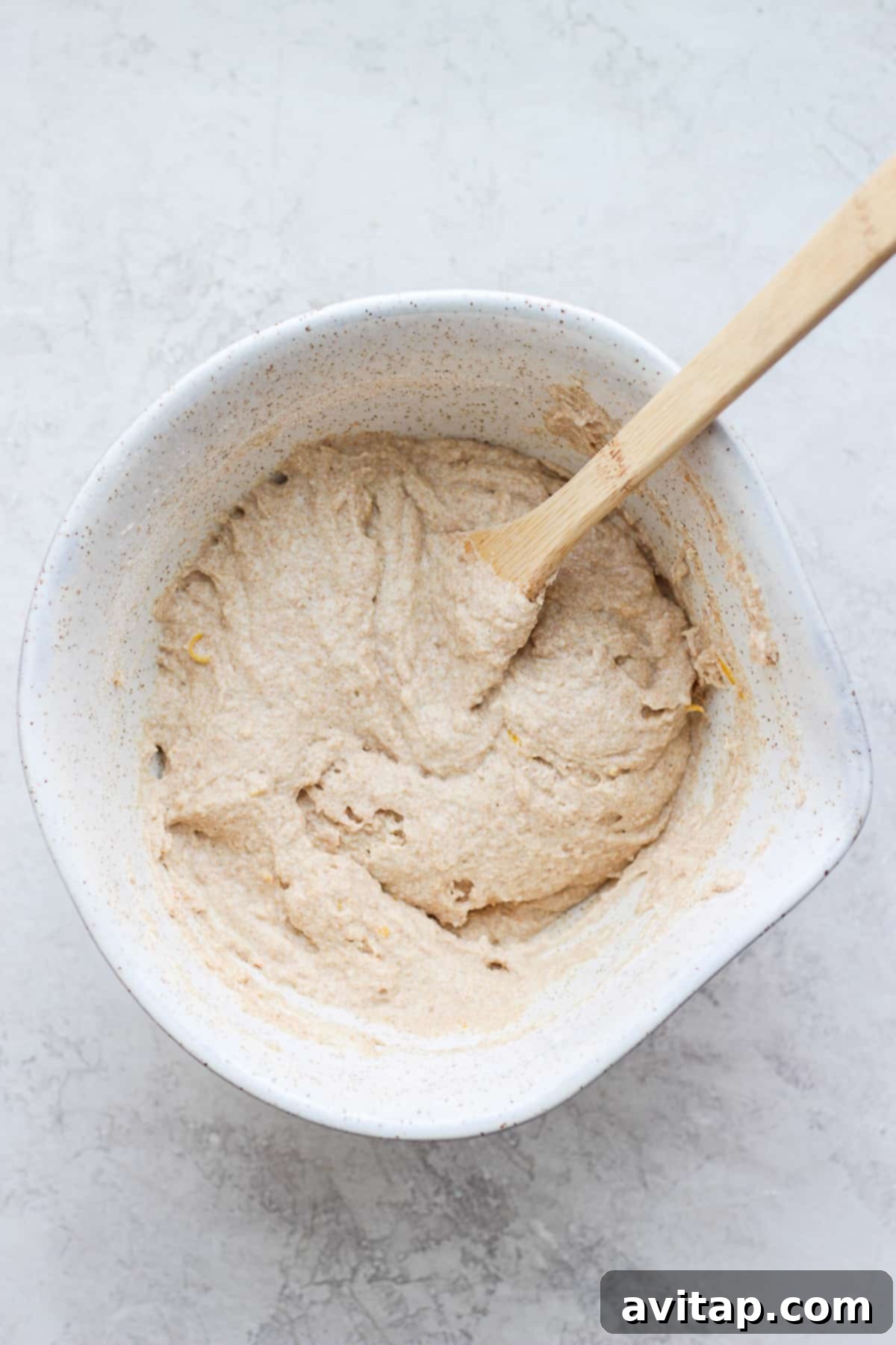 Close-up of fluffy pancake batter in a mixing bowl, ready to be cooked.