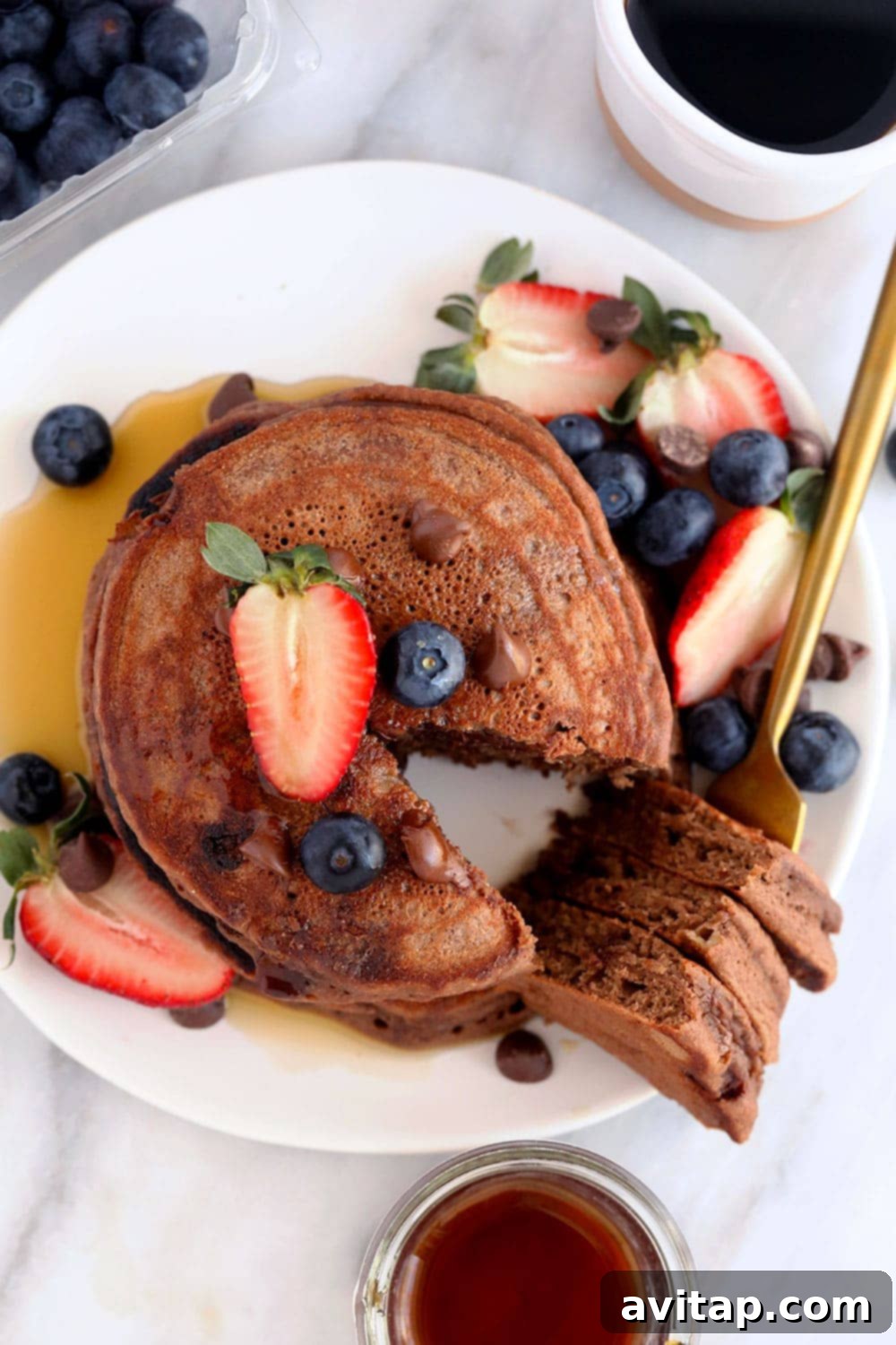 Healthy Chocolate Chocolate Chip Pancakes: A Family Favorite Breakfast Healthy chocolate chocolate chip pancakes on a plate garnished with fruit