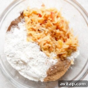 A bowl filled with flour, cinnamon, and coconut sugar, showing the dry ingredients for apple pancakes.
