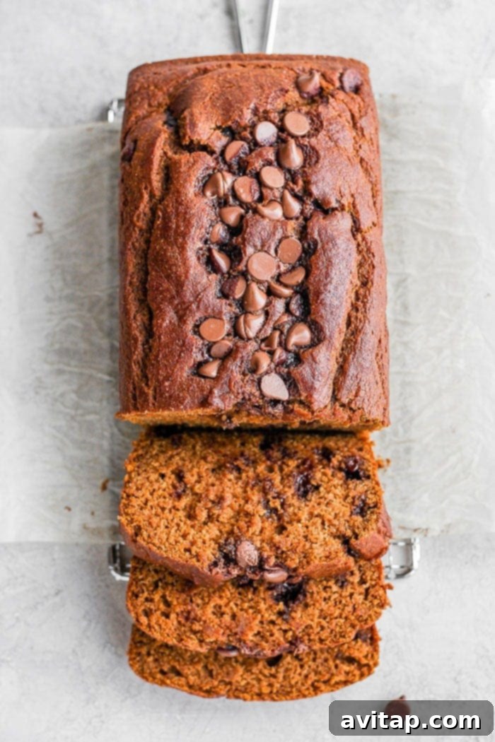 It’s pumpkin season! Which means it’s time to make this moist and flavorful Healthy Pumpkin Bread. Packed with pumpkin puree and a few chocolate chips + the just right amount of cinnamon, nutmeg, cloves and ginger, this pumpkin bread is something your whole family will enjoy! A perfectly baked, moist, and flavorful healthy pumpkin bread loaf, freshly sliced to reveal its tender interior and optional chocolate chips. Ideal for fall baking.