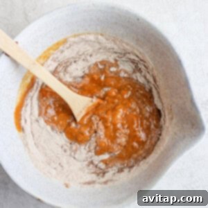 Wholesome Spiced Pumpkin Loaf 4 mixing wet and dry ingredients.