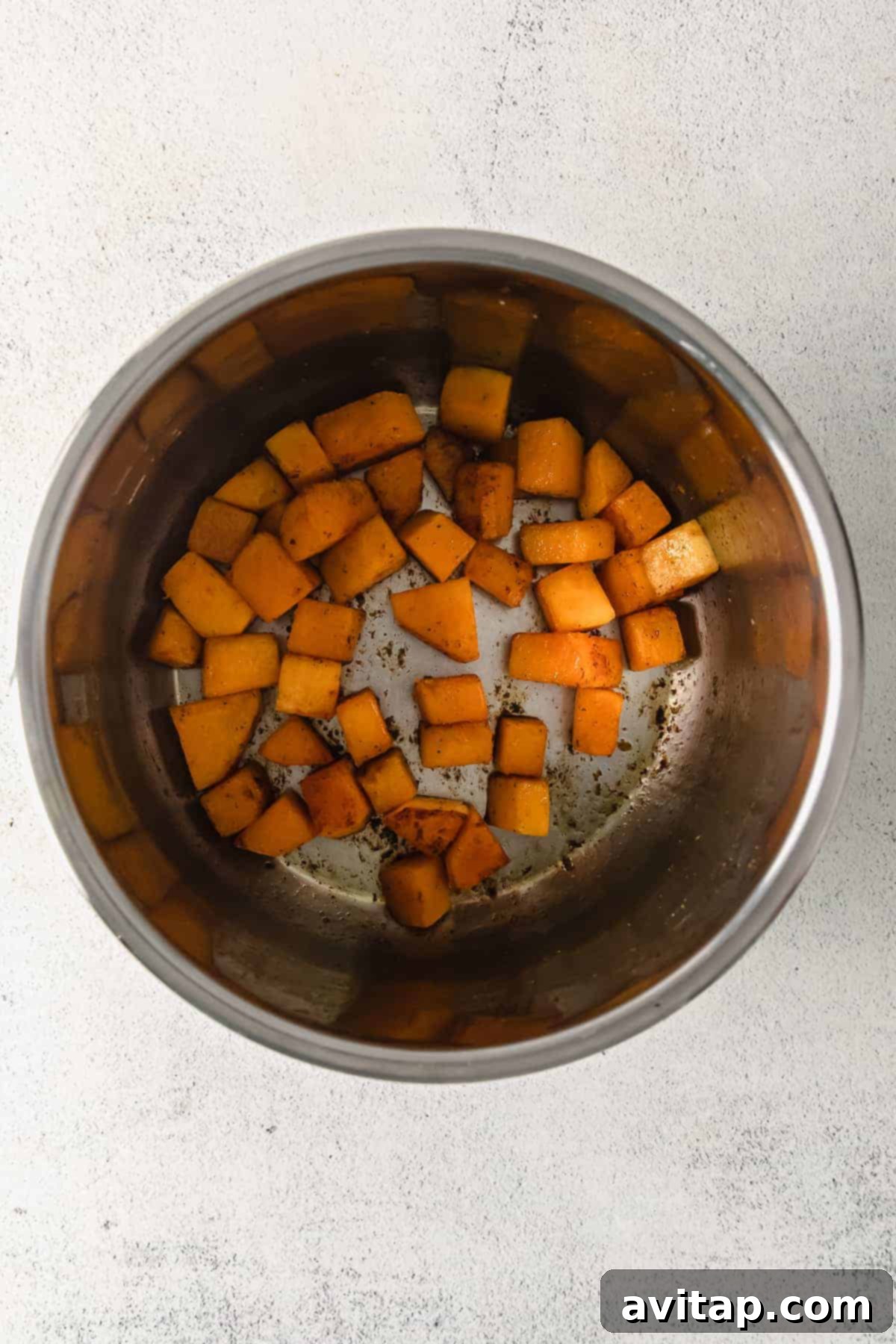 Butternut squash cubes cooking in an Instant Pot.