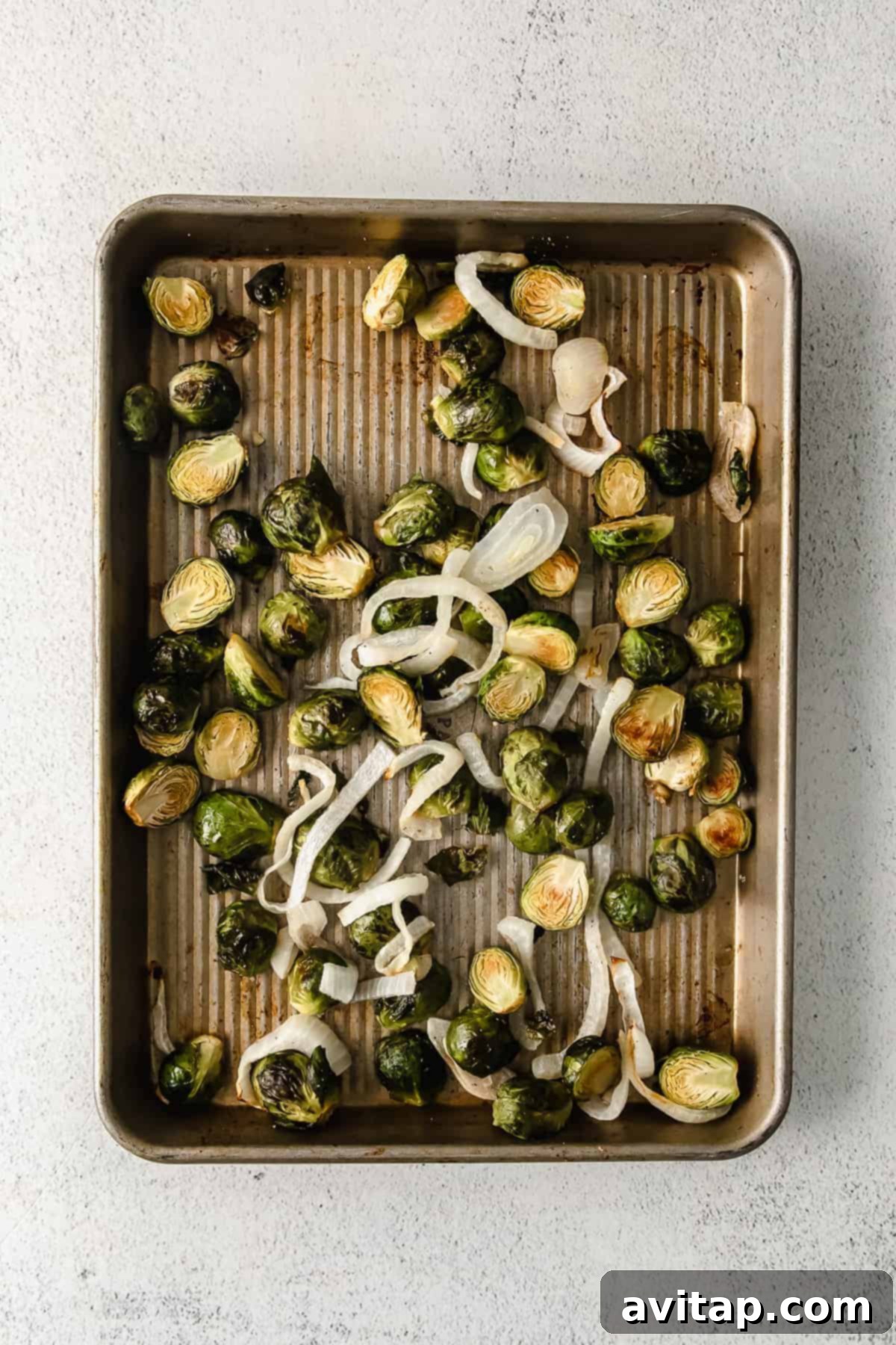 Perfectly roasted Brussels sprouts on a baking sheet.