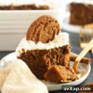 A smaller, square image of a slice of gingerbread on a plate, topped with cream cheese frosting, emphasizing its appetizing appearance.