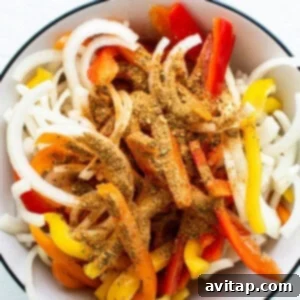 A bowl filled with peppers and onions.