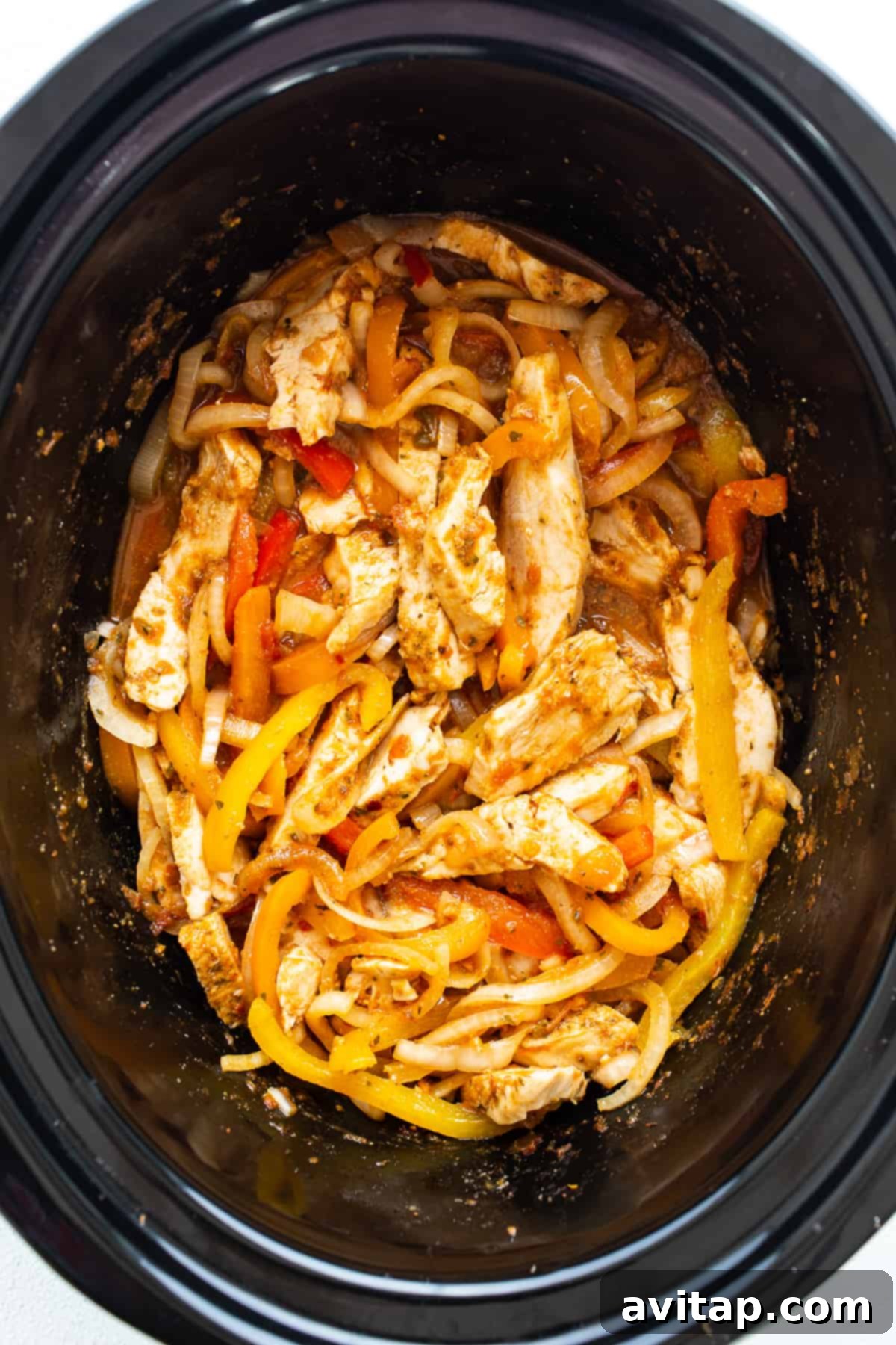 Chicken and peppers in a slow cooker.