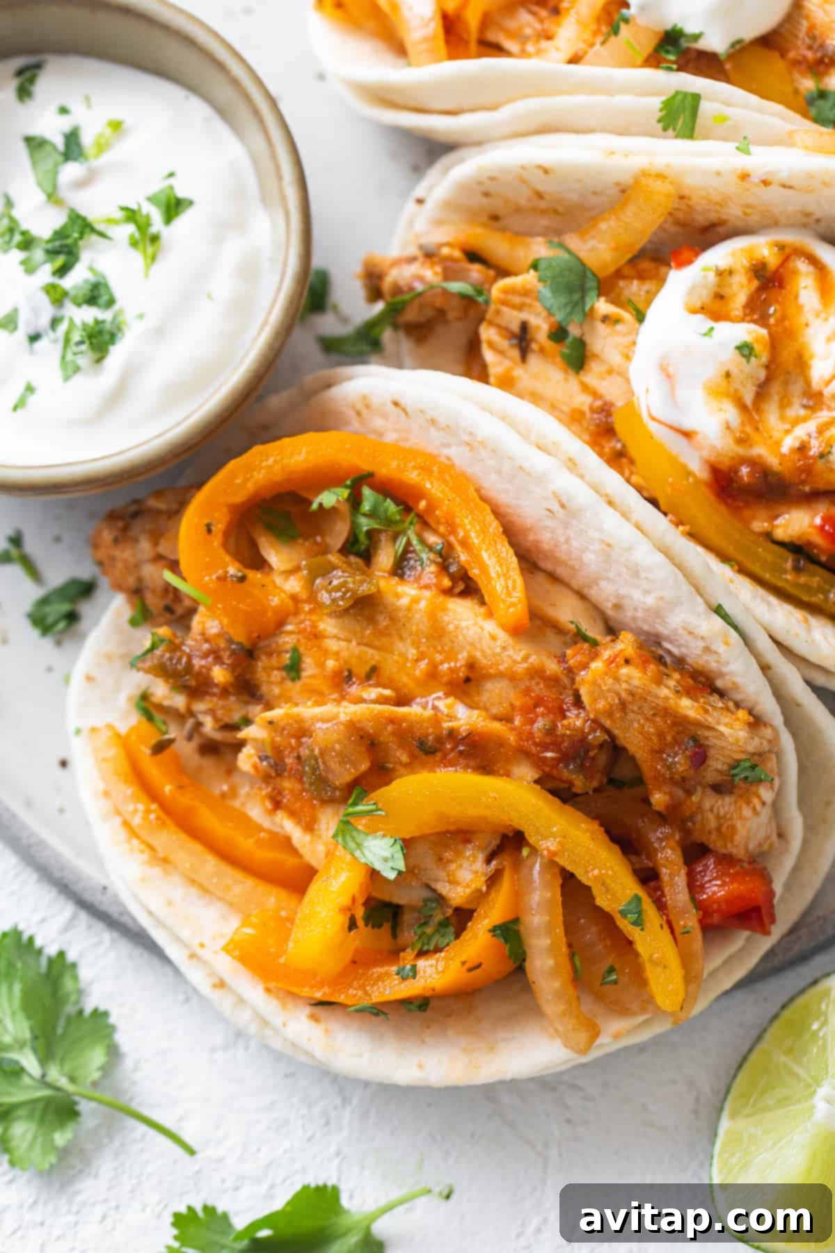 Chicken tacos with peppers and sour cream.