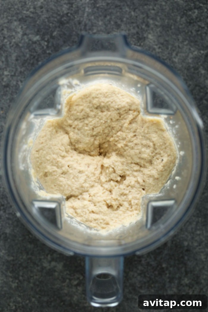 Creamy cauliflower mash being blended smooth in a high-speed blender, showcasing its luxurious texture.