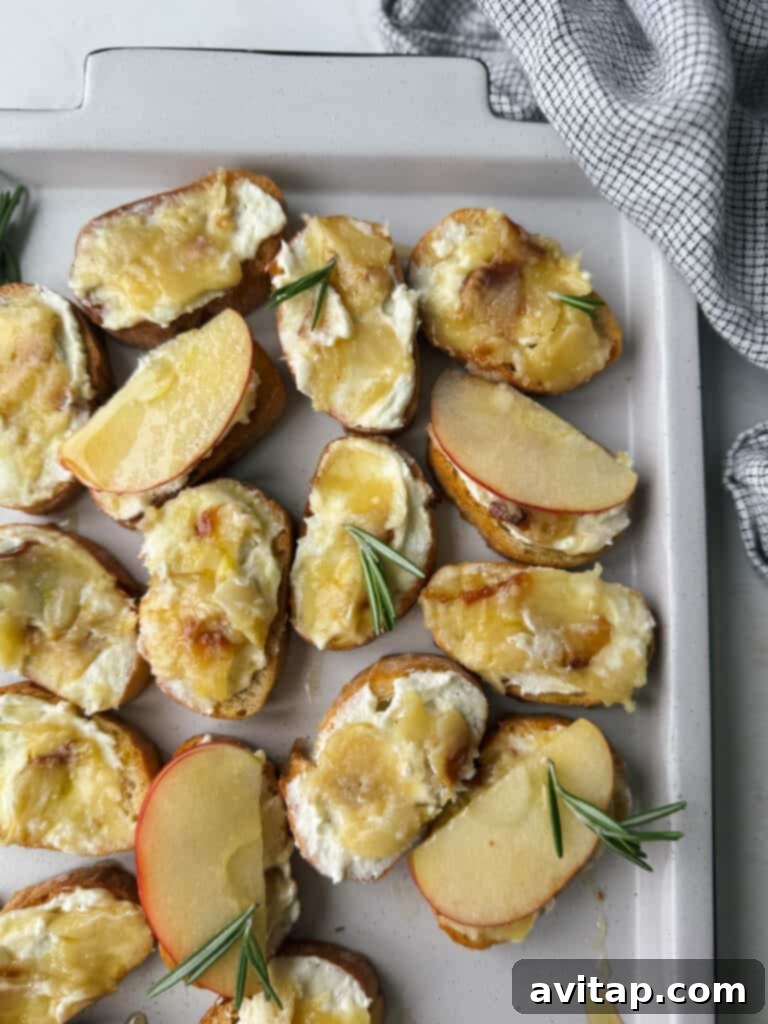 Rustic scene featuring roasted garlic bulbs, fresh rosemary, and a baguette, evoking a cozy and flavorful culinary experience.