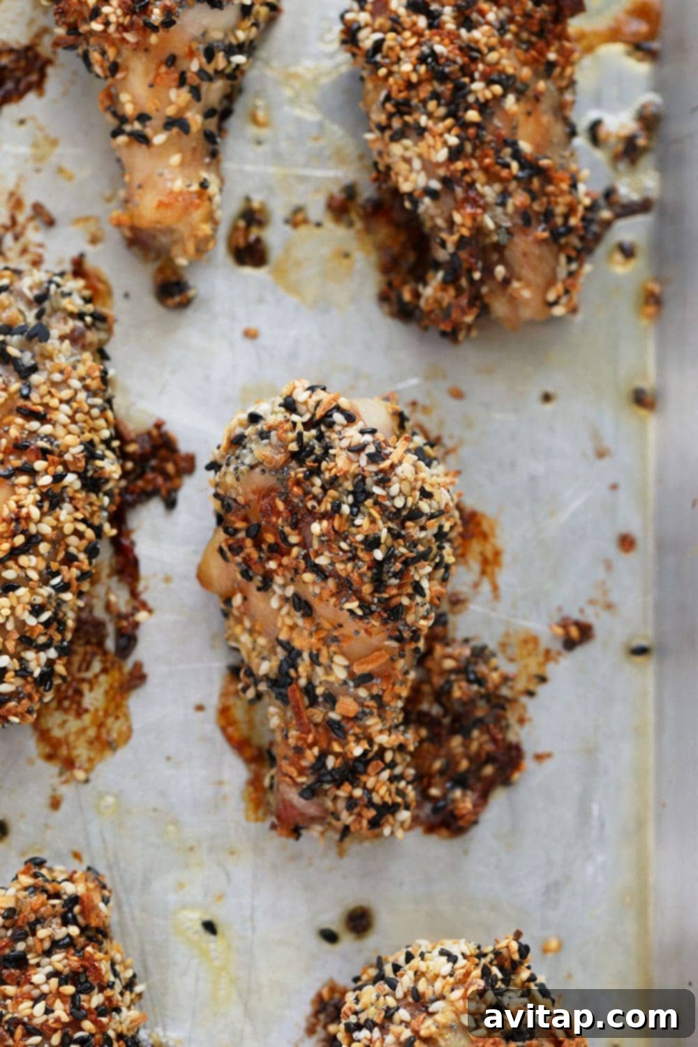 The CRISPIEST Chicken Wings! Close-up of golden brown, crispy Everything Bagel seasoned chicken wings fresh out of the oven.