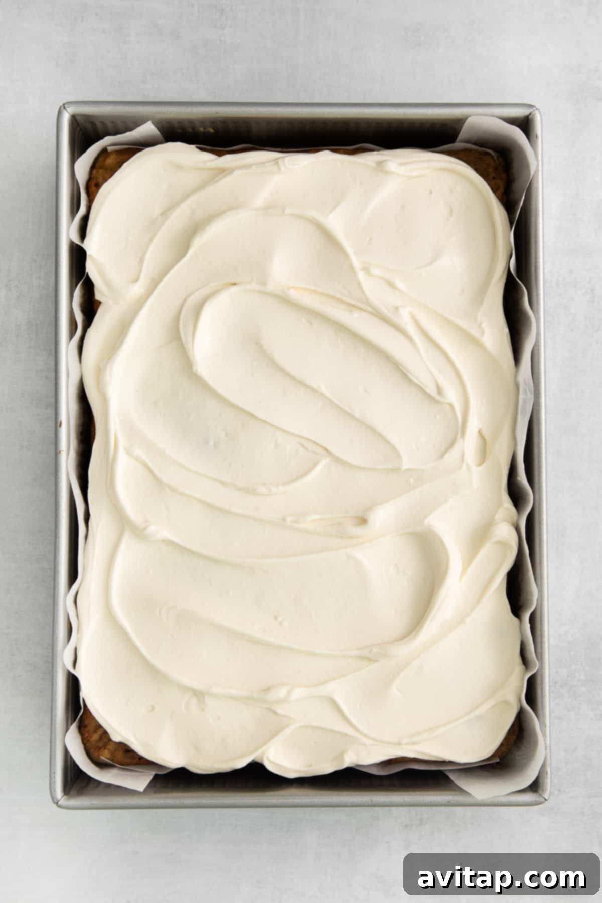 A beautifully frosted apple cake ready to be served.