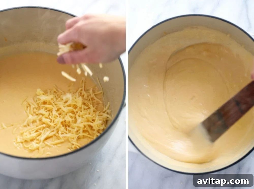 A chef's hands whisking a creamy white sauce in a large stainless steel pot, demonstrating the start of a mac and cheese sauce.