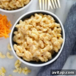 Two delectable bowls of macaroni and cheese on a sleek marble table, showcasing a savory mac and cheese recipe.
