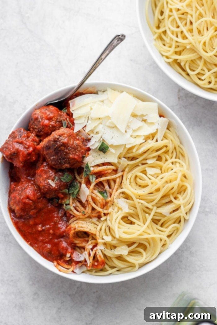 Classic Italian Spaghetti and Meatballs, a perfect family dinner. Delicious spaghetti and meatballs served on a white plate, ready to be enjoyed.