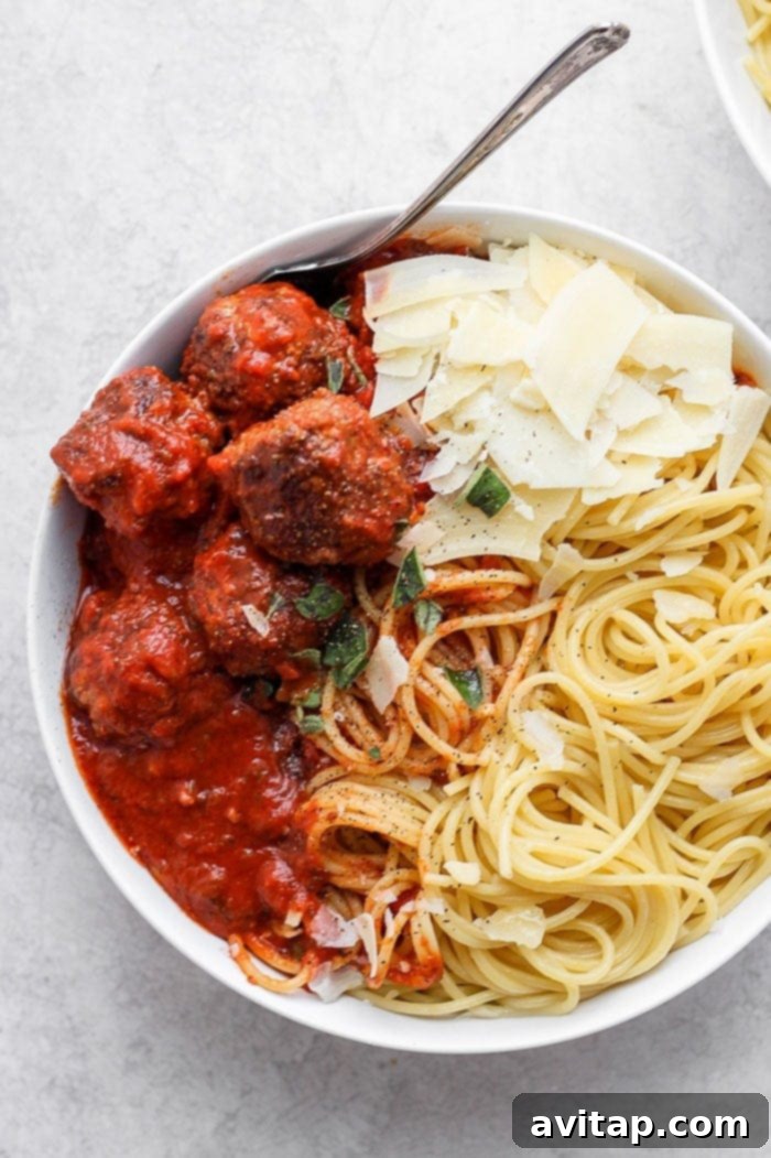 This easy Italian meatball recipe, made with ground beef, breadcrumbs, Parmesan, and marinara, is truly the best! A cozy bowl of spaghetti with three large, succulent meatballs and a sprinkle of Parmesan cheese.