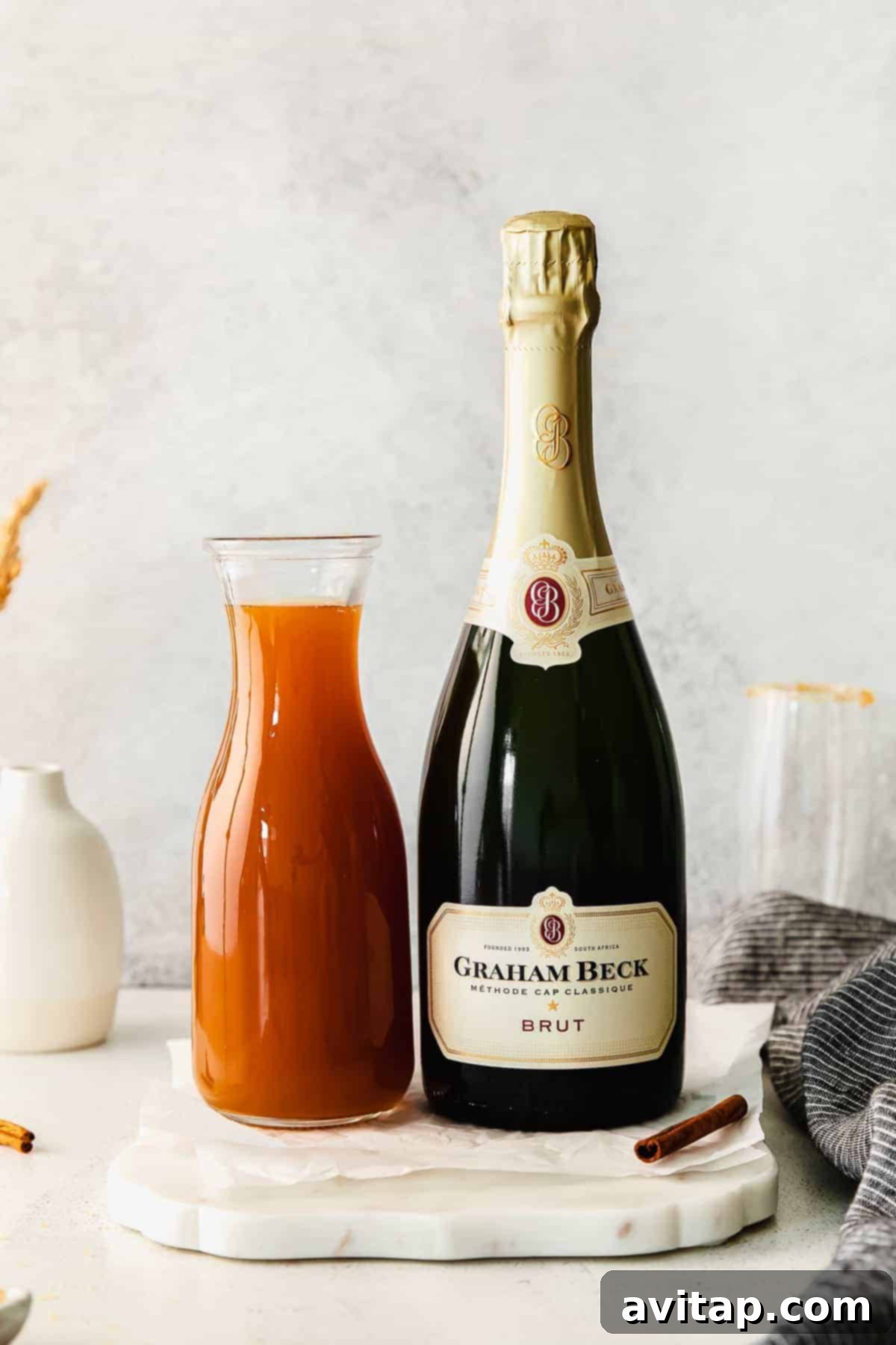 Autumn Apple Mimosa 3 Two champagne flutes filled with a golden Apple Cider Mimosa, ready to be served.