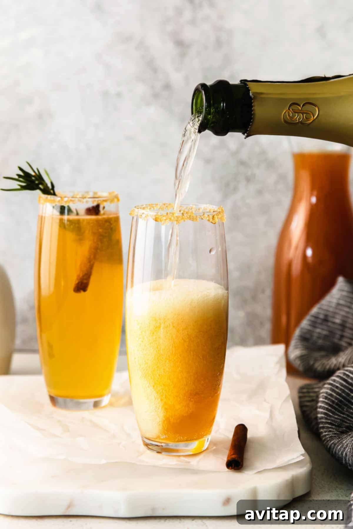 Autumn Apple Mimosa 6 Close-up of champagne being poured gently into a glass for an Apple Cider Mimosa.