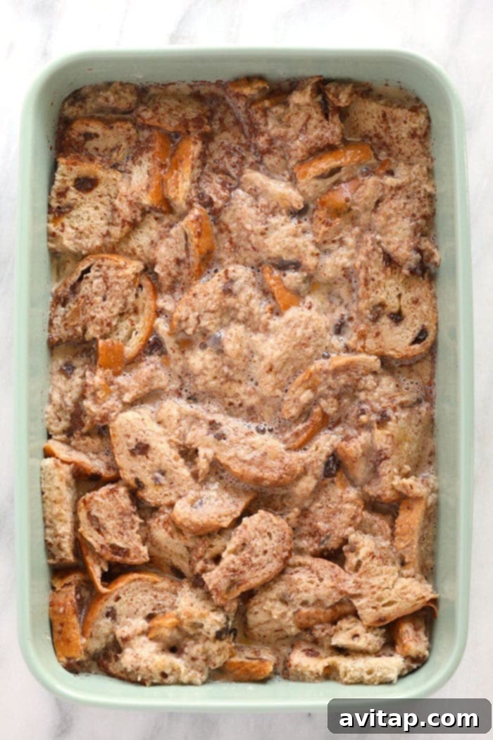 A warm, golden-brown cinnamon French toast bake fresh out of the oven in a glass casserole dish.