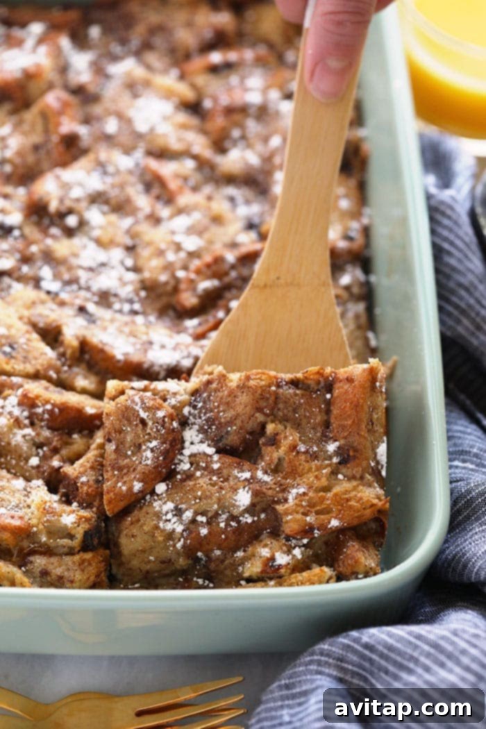 A large glass casserole dish filled with baked cinnamon French toast, ready to be served.