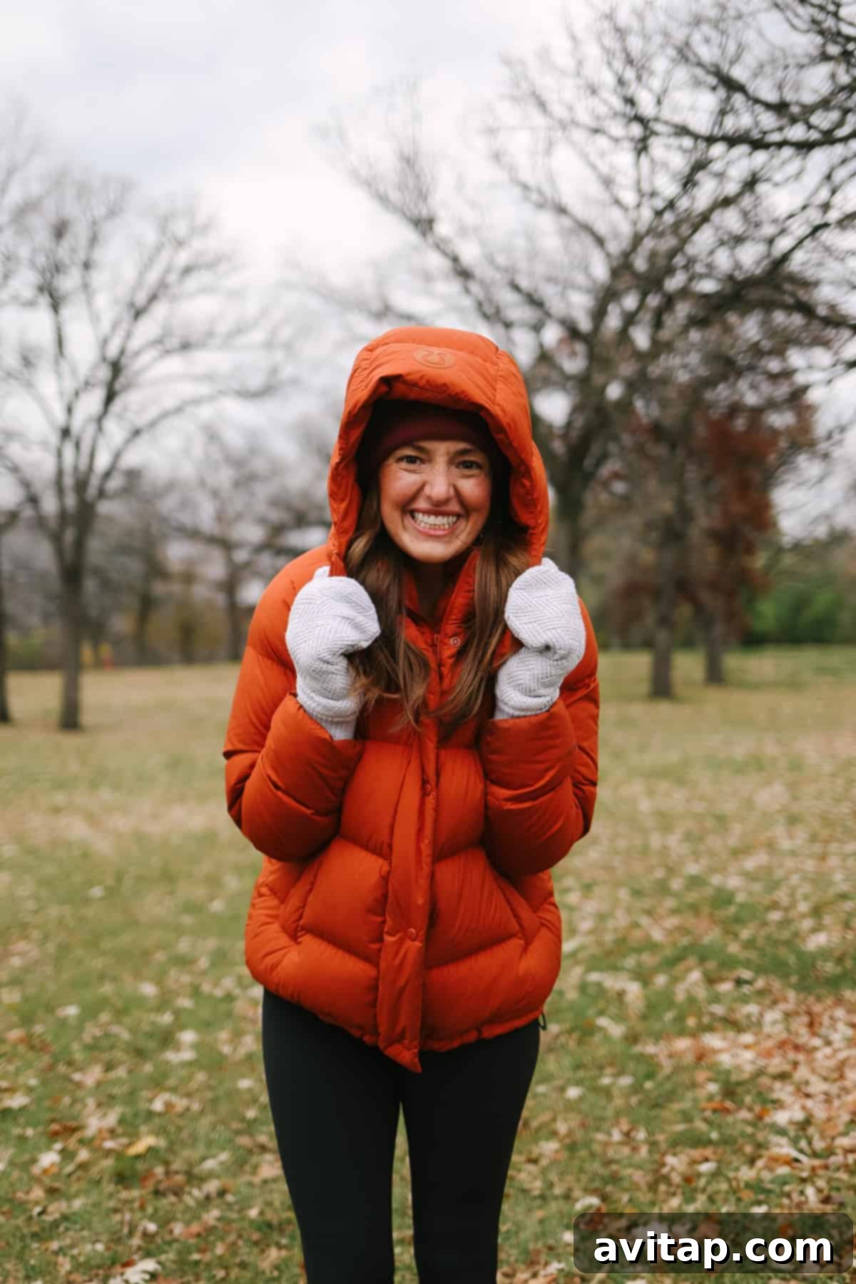 A smiling woman looking warm and cheerful in a Lululemon Wunder Puff Jacket.