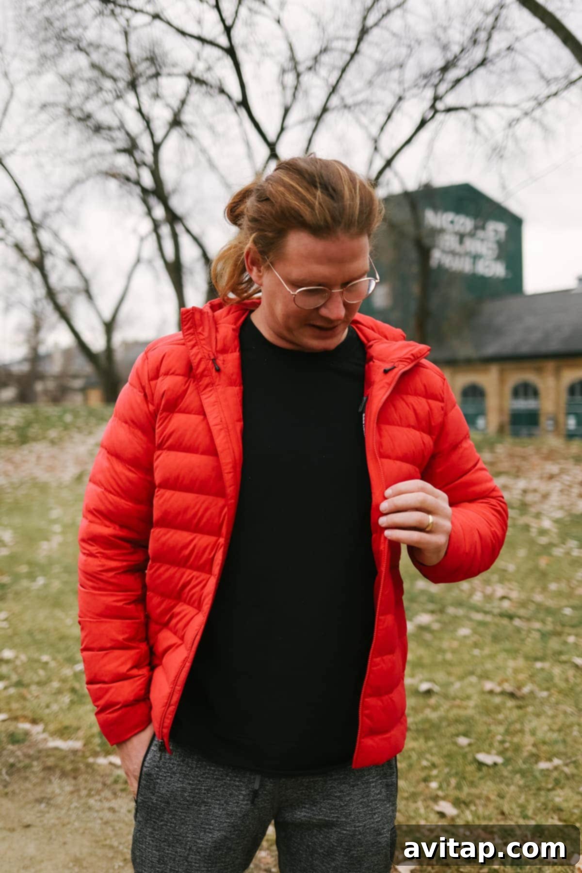 A man smiling and looking warm in a Lululemon Navigation Down Hoodie.