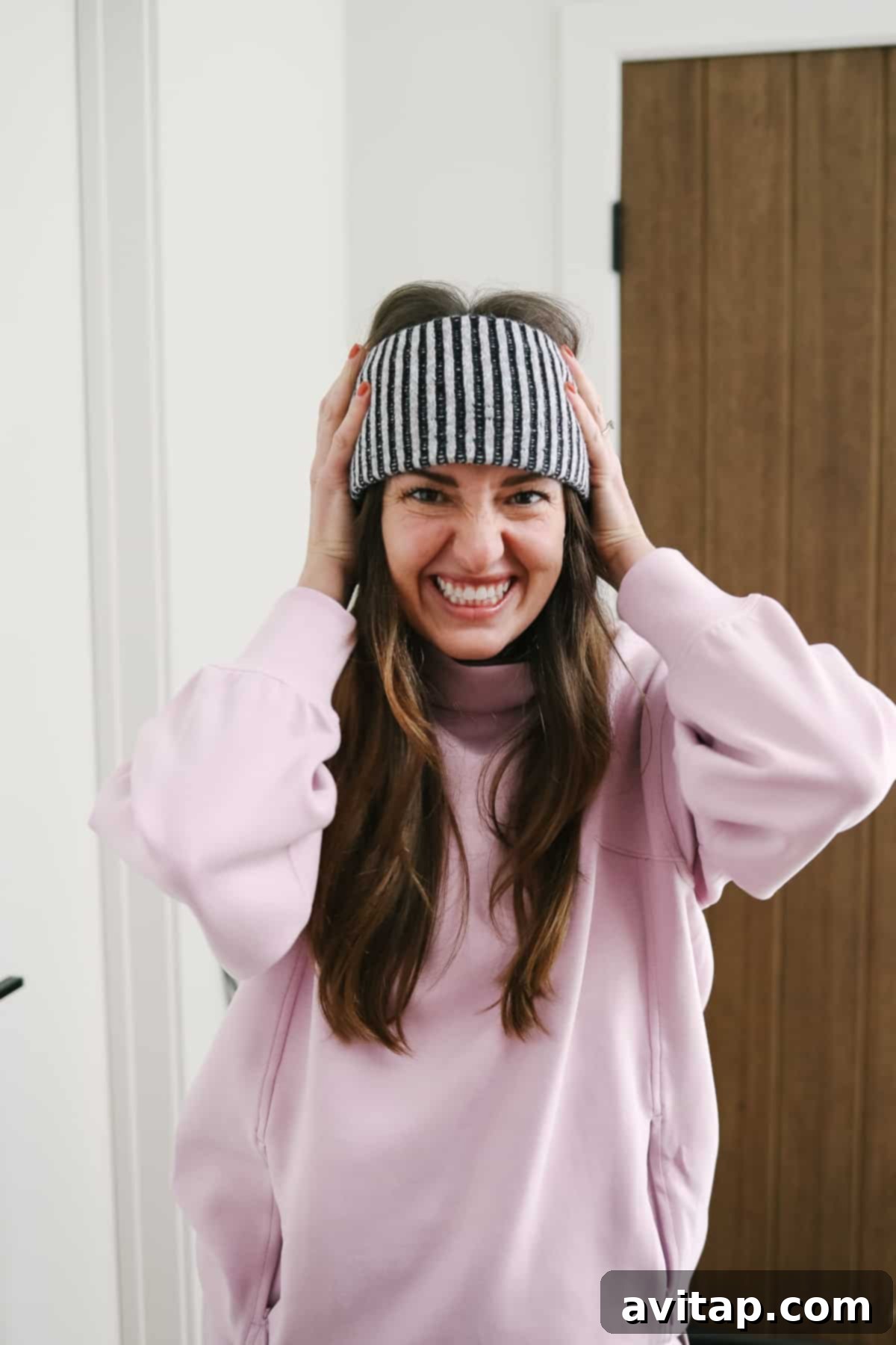 A woman elegantly wearing a Lululemon textured fleece-lined ear warmer, perfect for cold weather.
