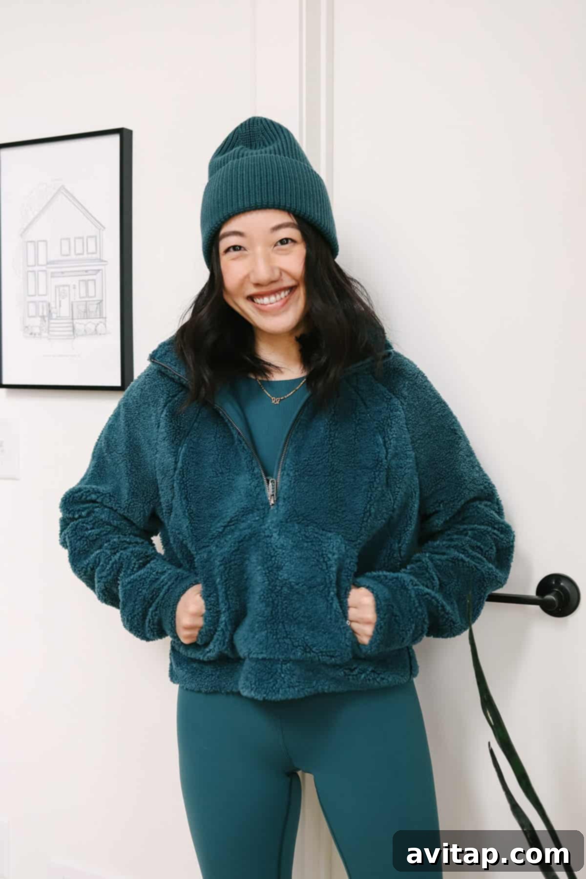 A woman looking chic and comfortable in a Lululemon cozy sherpa zip-up top, ideal for winter.