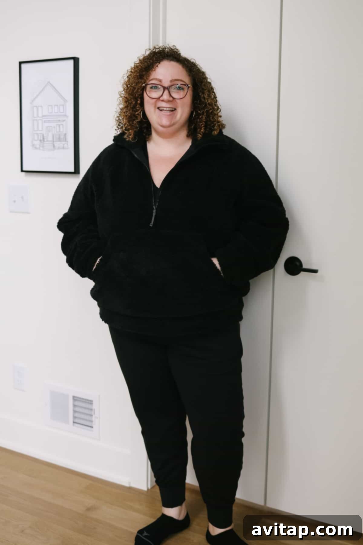 A woman looking stylish and warm in a Lululemon cozy sherpa zip-up top, perfect for layering.