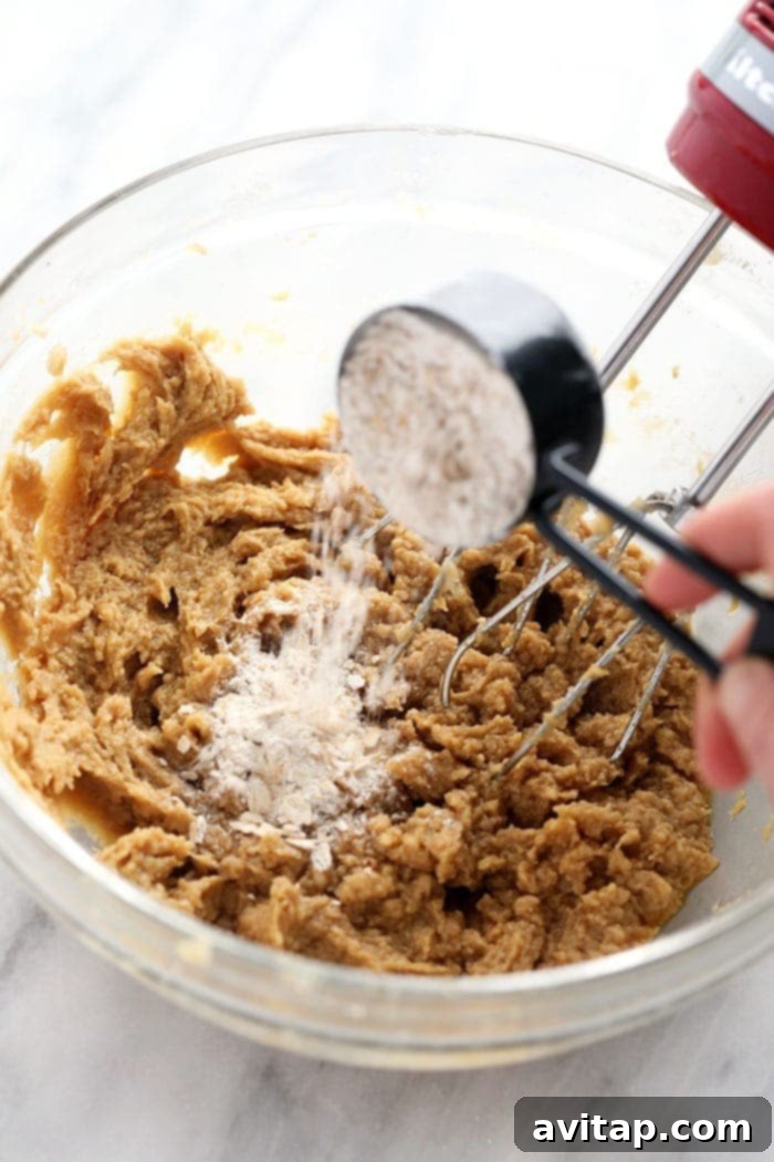Preparing the Perfect Old-Fashioned Iced Oatmeal Cookie Batter Oatmeal cookie batter being mixed in a bowl, showcasing its rich, textured consistency