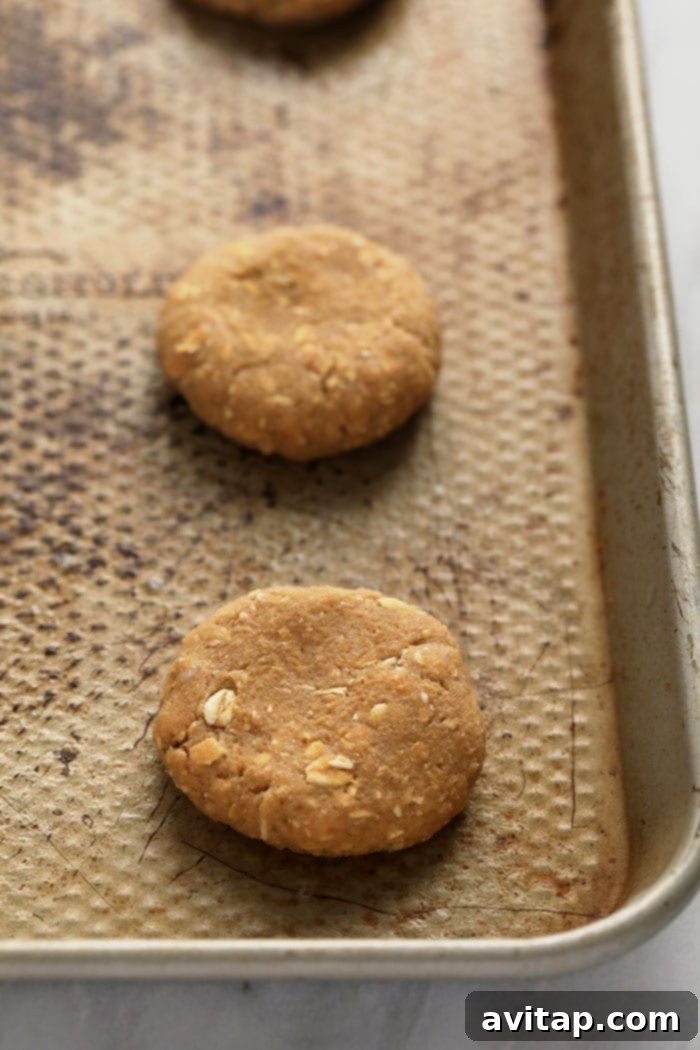 Perfectly Portioned Cookie Dough Ready for Baking Scooped cookie dough balls gently pressed onto a parchment-lined baking sheet